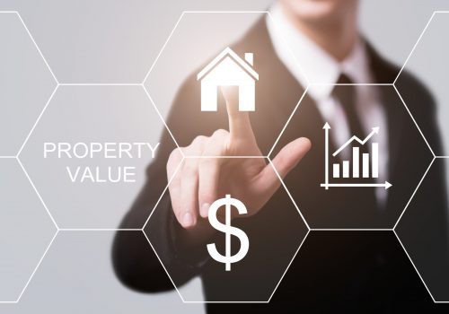 businessman pressing button on virtual screens property value